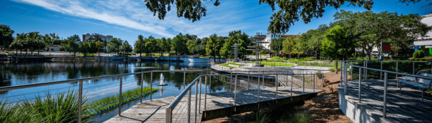 Walkway with guardrail at a stormwater pond with GSI plantings